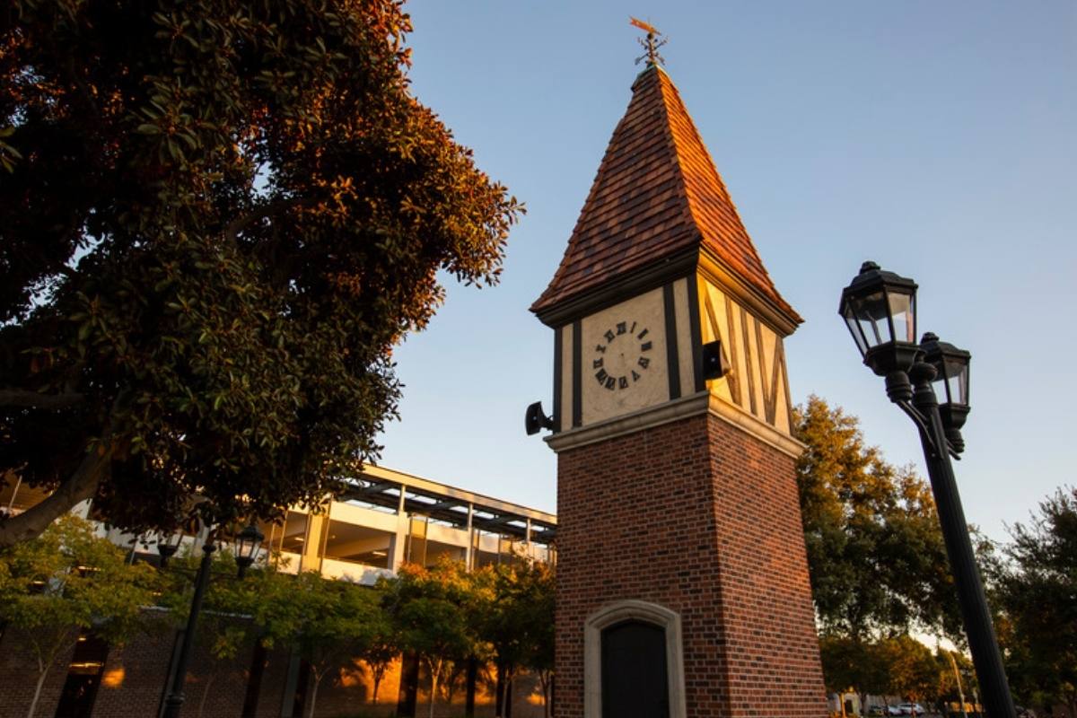 Brick clock tower in Westminster, Orange County, at sunset